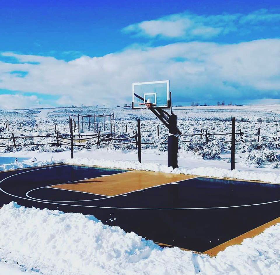 Snowy backyard basketball court