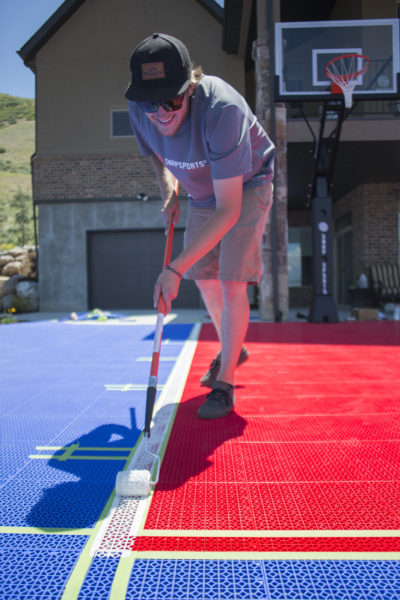 SnapSports expert installer painting court lines