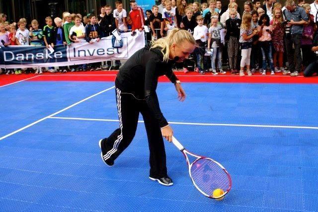 Danish professional tennis star Caroline Wozniacki serving it up on SnapSports tennis surfacing