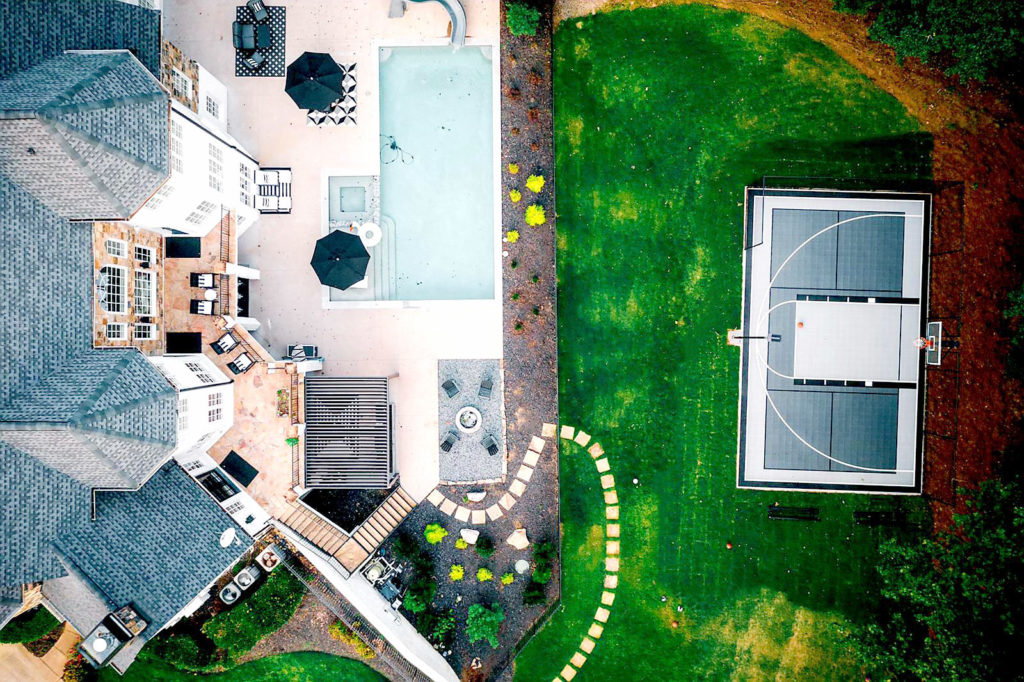 Drone view of 30' x 46' backyard multi-court in gray and graphite