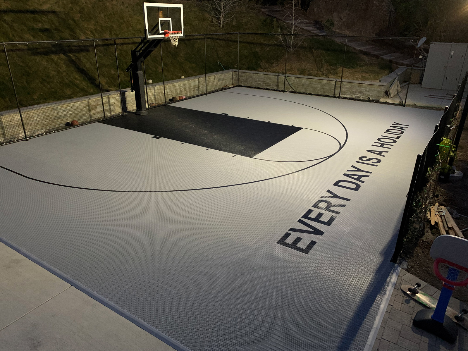 Backyard basketball half-court with custom painting