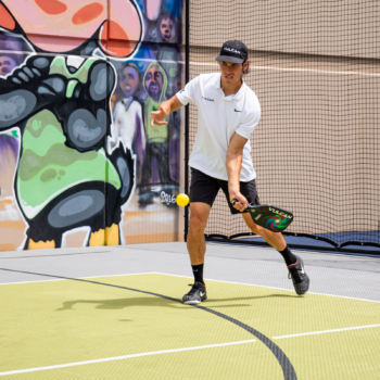 Tyler Loong, Utah Pickleball Professional, tests out the court with a game of Pickleball
