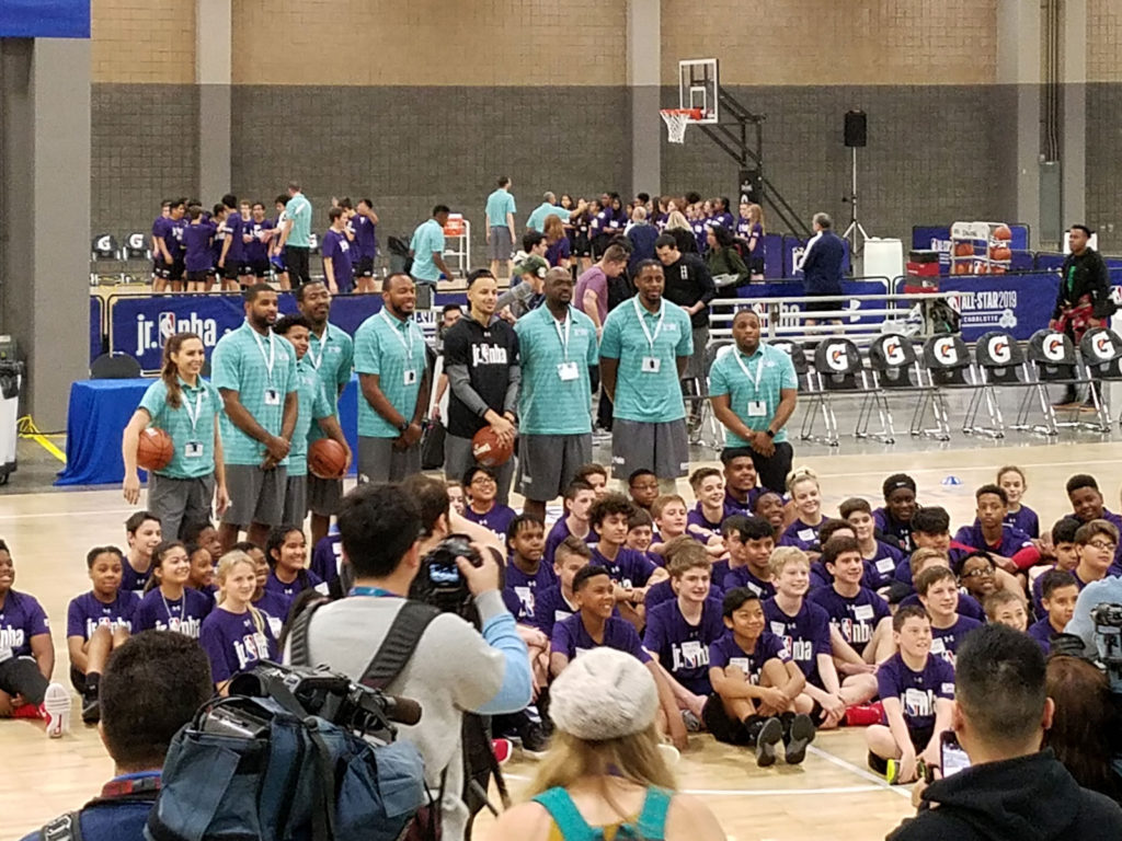 The All-Stars and Jr. NBA participants pose for a group photo