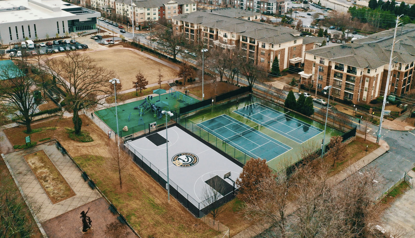 Drone shot of the new basketball court next to the tennis courts and playground