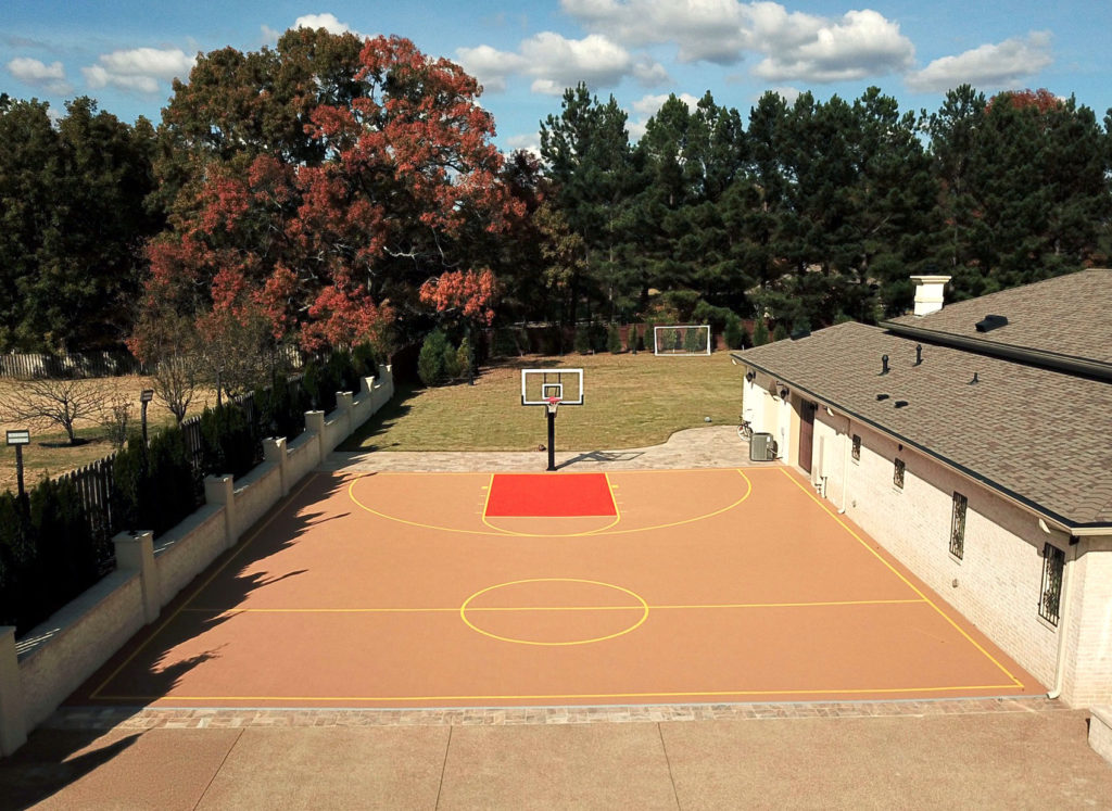 Multicolor residential basketball court with yellow sport lines