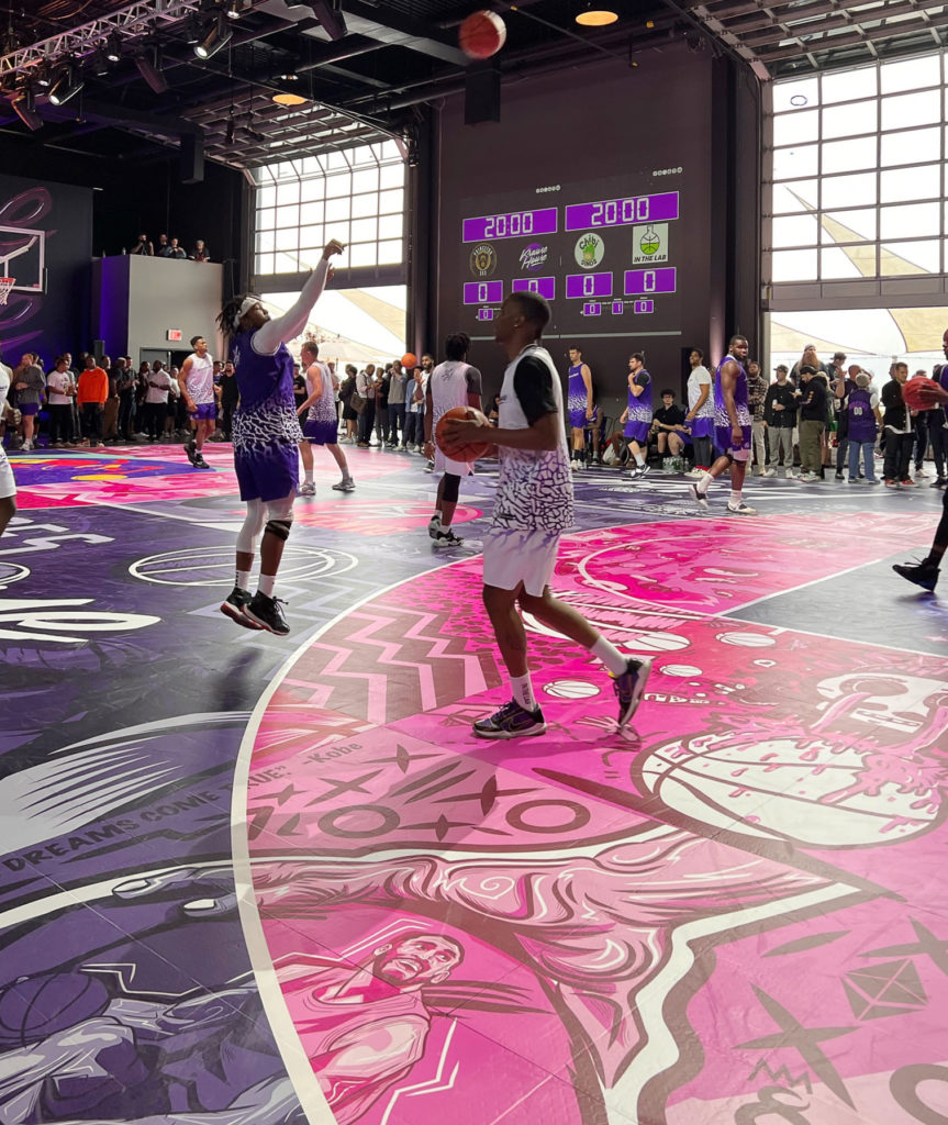 Basketball players on a completely custom pink and purple court