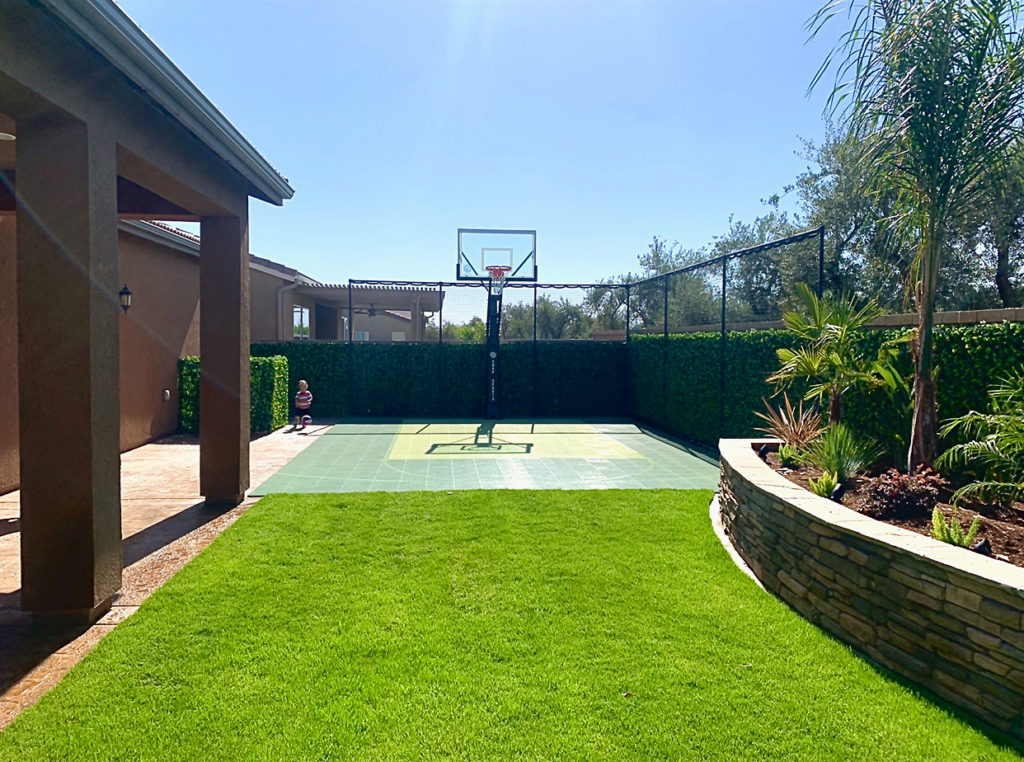 Another view of the green basketball half-court in the backyard