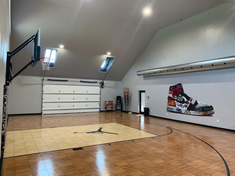 Indoor BounceBack dark maple and light maple basketball court in garage