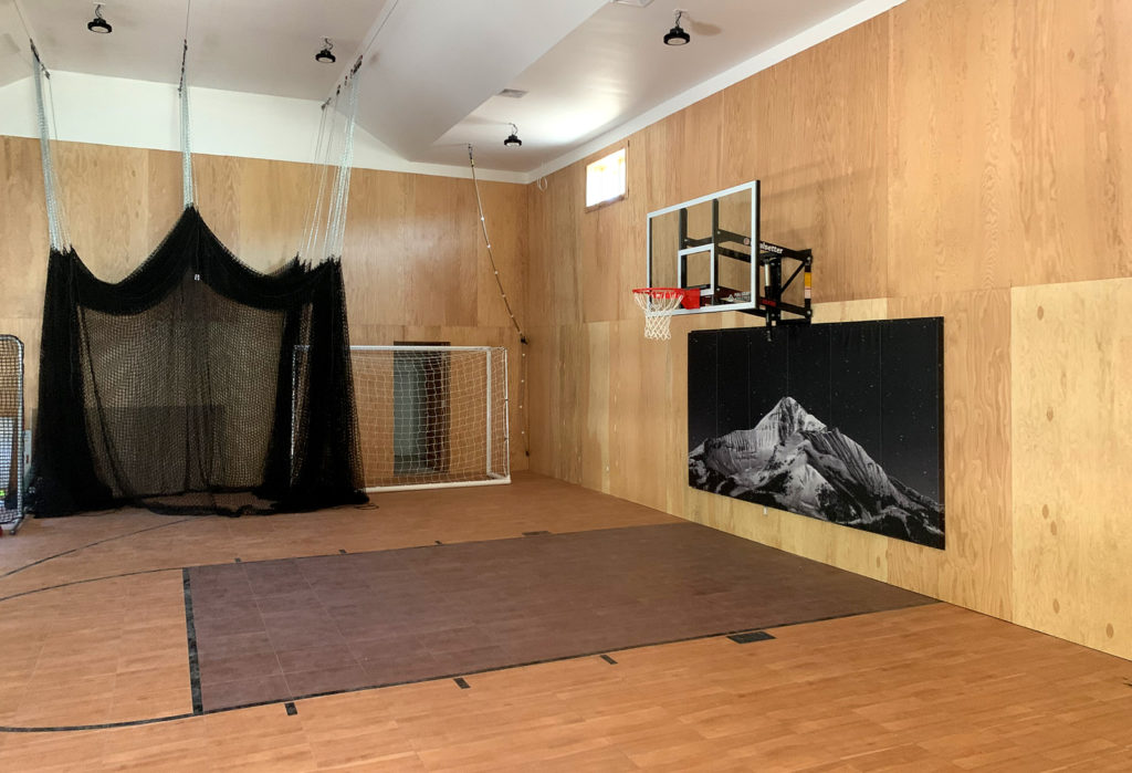 Indoor basketball court and gym with BounceBack maple and dark maple flooring