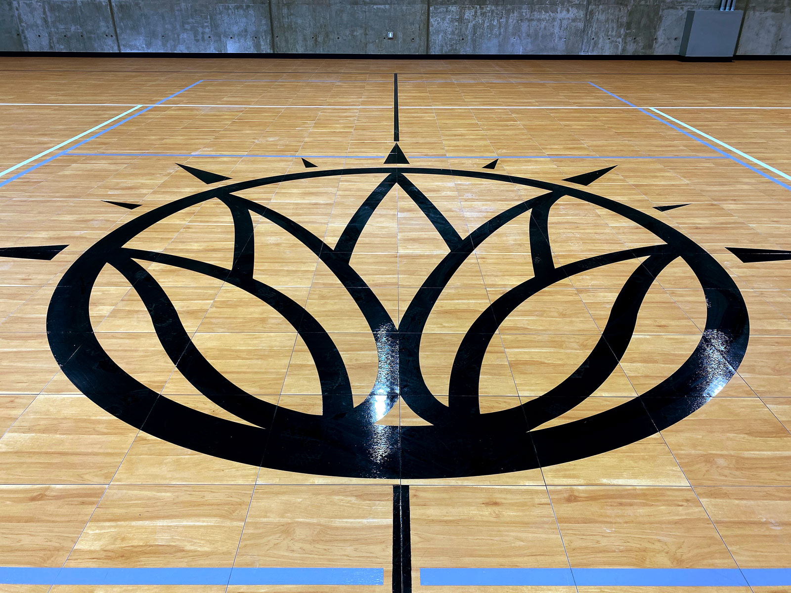 The custom Soleil Lofts logo on the court.