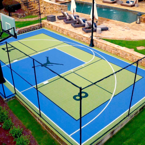 Drone view of backyard multi-court in bright blue and kiwi