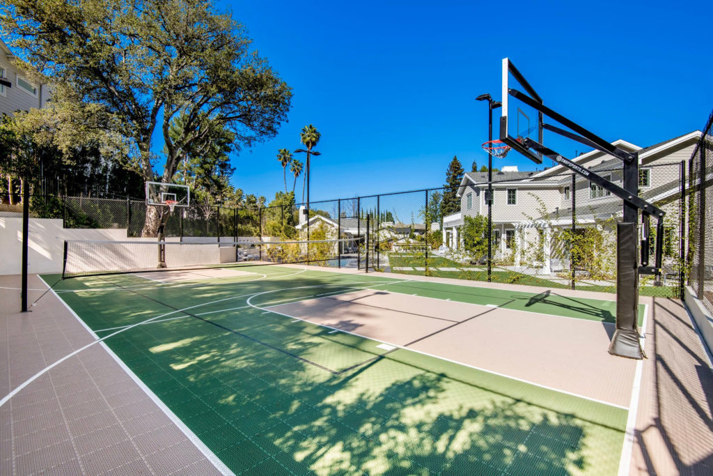 Outdoor Revolution large full multi-court with basketball hoops in green and beige colors