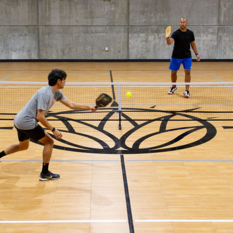 Playing Pickleball in the center of the court.