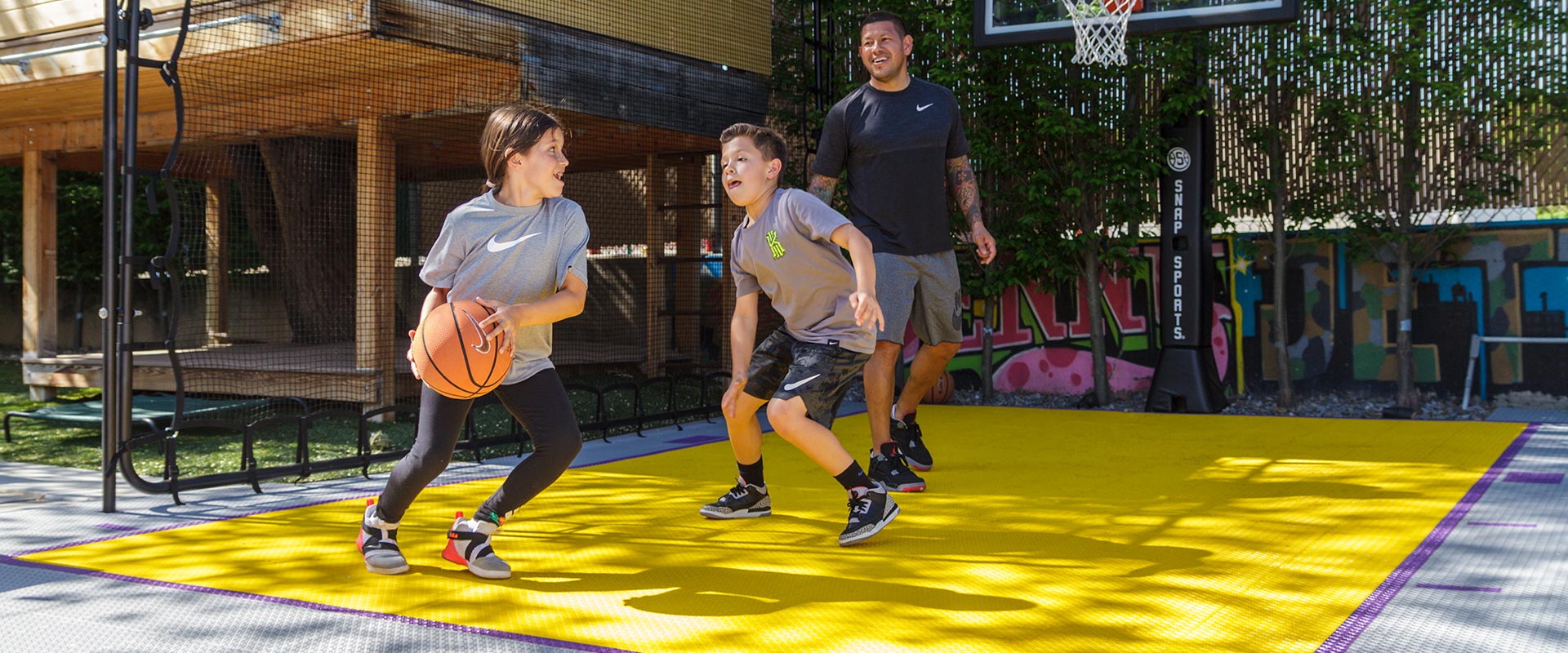 Nick Rimando and his kid play a game of basketball