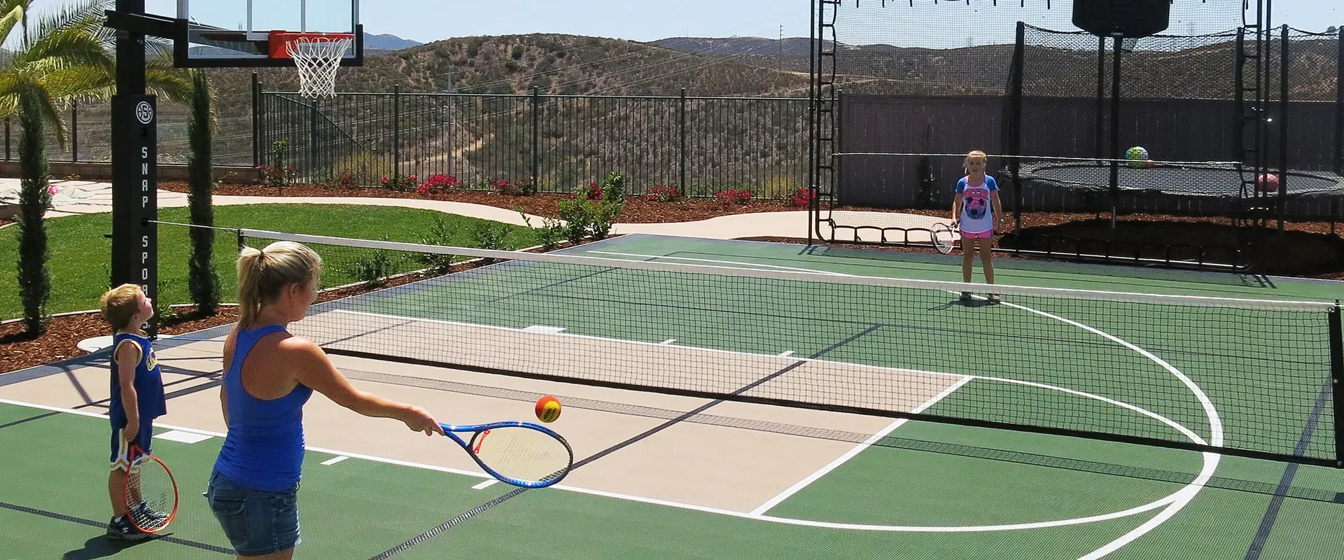 family plays tennis at home