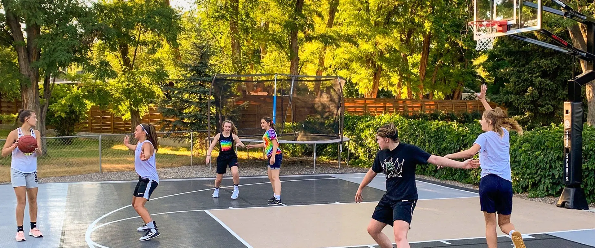 Teen girls play a pickup game of basketball