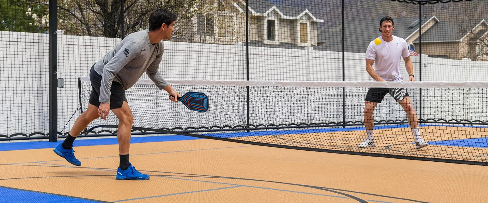 Tyler Loong plays pickleball on a home court