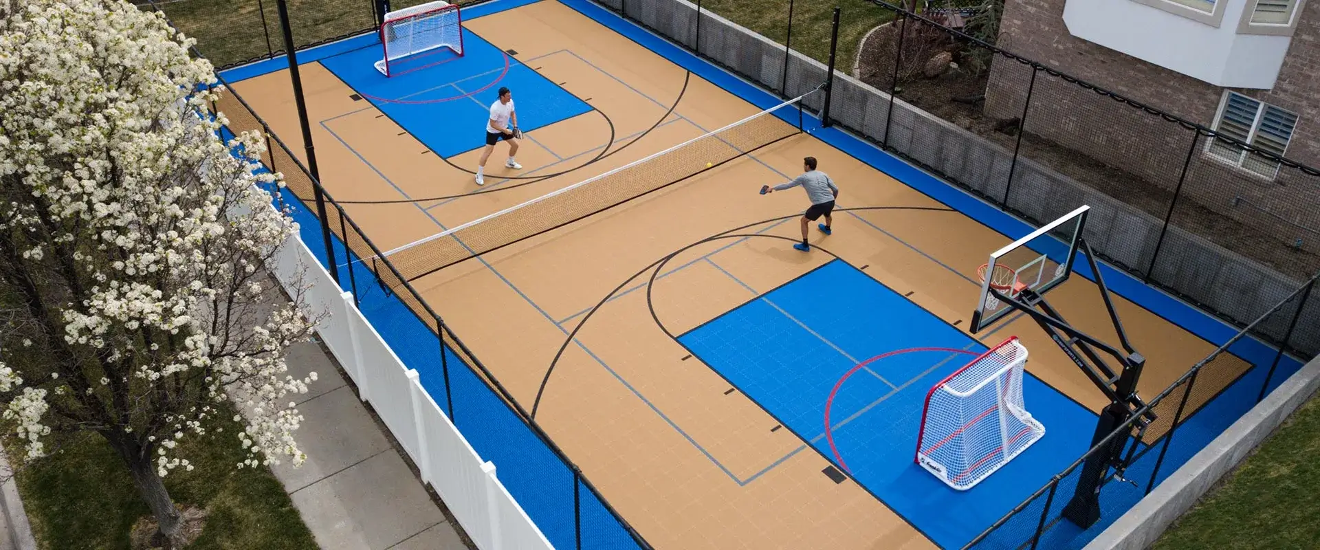 A game of pickleball being played in a backyard