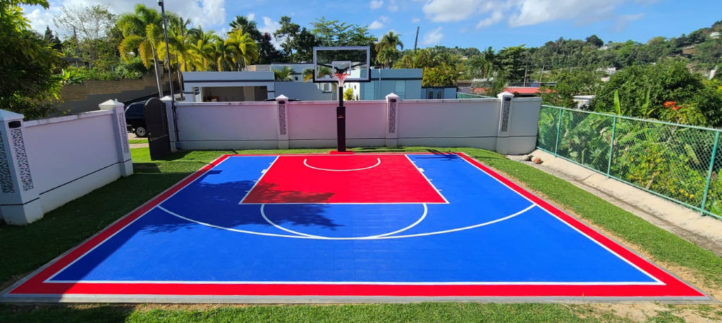 Backyard basketball half court in red and blue in Puerto Rico
