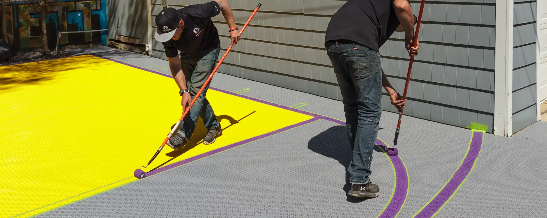 SnapSports Installer Two certified SnapSports installers paint a home court.