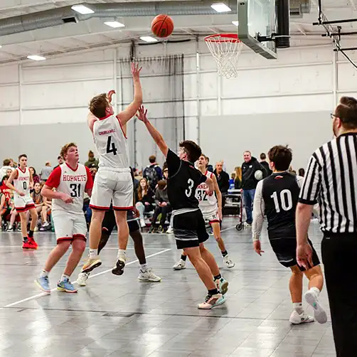 score A boy scores a basket during a basketball game on SnapSports.