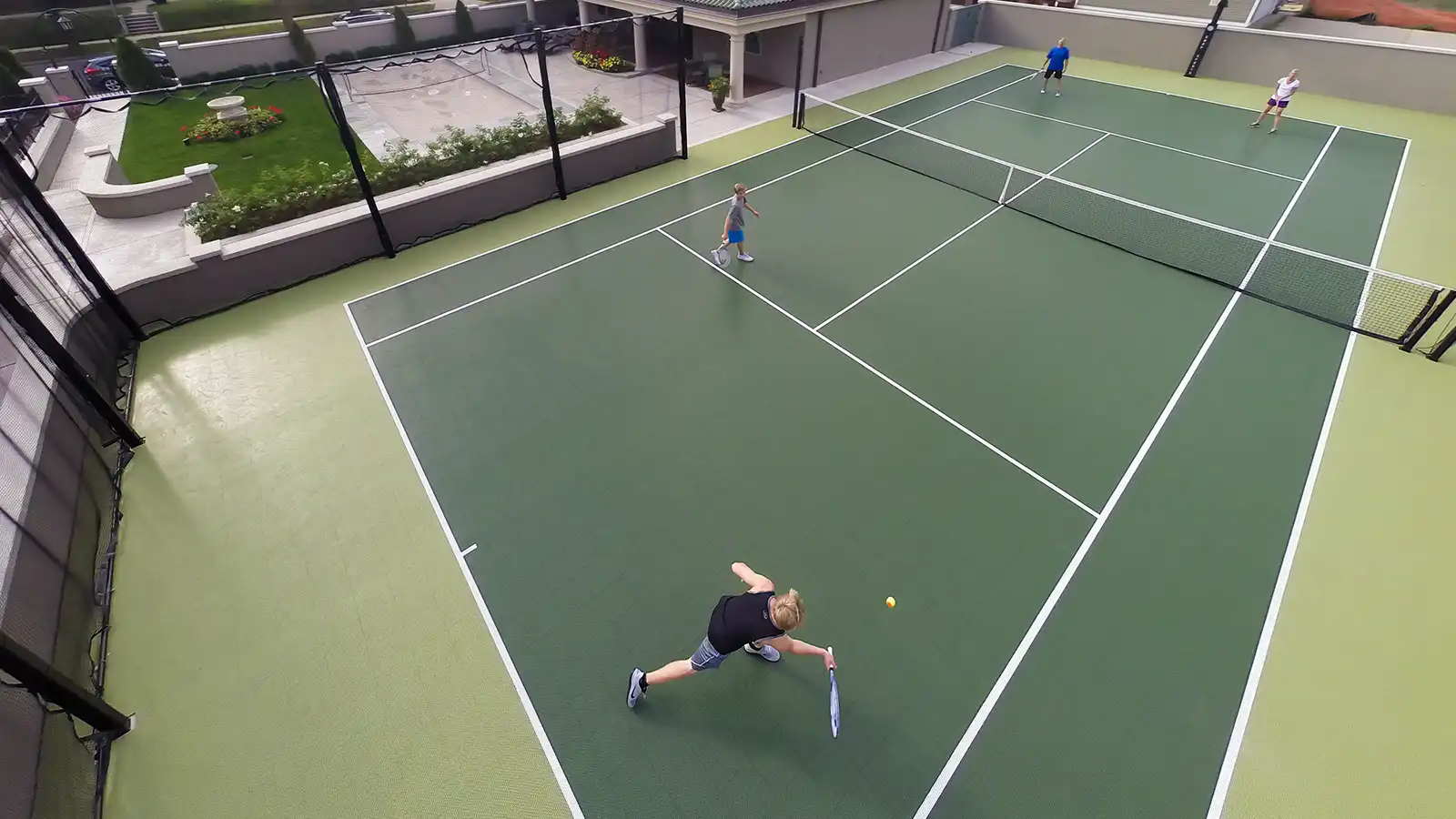 tennis A family plays tennis at a private club